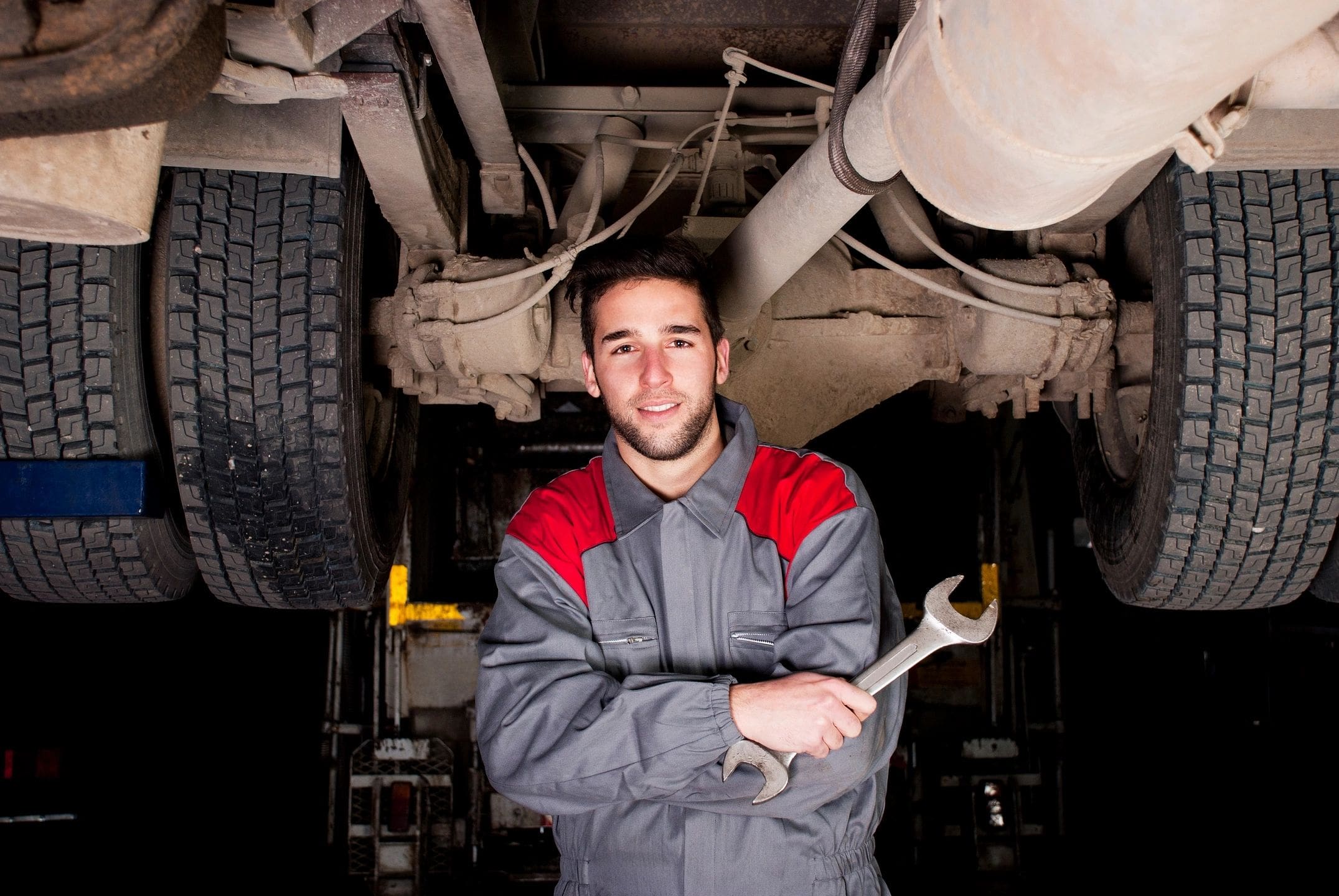 A man holding a wrench in his hands.