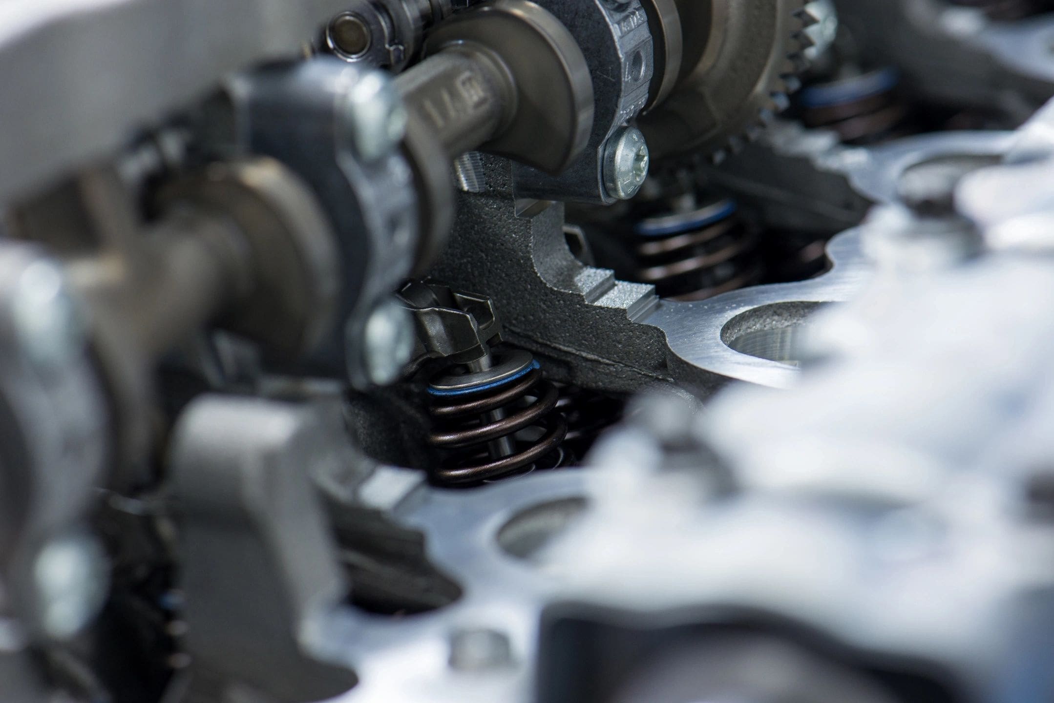 A close up of the valves and pistons on a car engine.